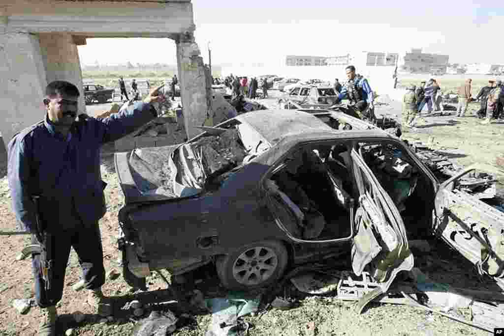 Iraqi security forces inspect the site of a bomb attack in Kirkuk. (Reuters)