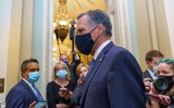 Sen. Mitt Romney, R-Utah, leaves the Senate Chamber following a vote, at the Capitol in Washington, Sept. 21, 2020.