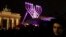 A giant Hanukkah Menorah set up by the Jewish Chabad Educational Center, is illuminated at the Pariser Platz in front of the Brandenburg Gate in Berlin, Tuesday, Dec. 12, 2017. (AP Photo/Markus Schreiber)