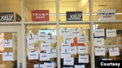 Anti-Trump messages are seen posted on window panels outside the GOP Badgers' room at the Student Activities Center on campus at the University of Wisconsin-Madison. (J. Kiah)