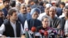 India's Congress Party President Sonia Gandhi, front, and her son and party Vice President Rahul Gandhi, left, addresses the media about her corruption accusation in New Delhi, India, Dec. 19, 2015. The Gandhis deny the allegations.