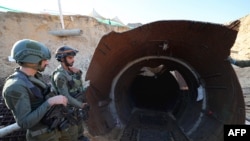 In this picture taken during a media tour organised by the Israeli military on December 15, 2023, soldiers stand at the entrance of a tunnel that Hamas reportedly used to attack Israel through the Erez border crossing on October 7.