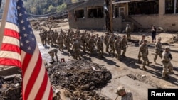 Army soldiers from 1st Battalion, 502nd Infantry Regiment, 101st Airborne Division arrive in Marshall, North Carolina, to help residents to clean up after Hurricane Helene, Oct. 8, 2024. 