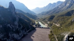 This aerial view shows waste stuck at the dam on the Neretva river caused by landslides, torrential rain and flash floods in Grabovica, Bosnia, Oct. 13, 2024.