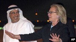 Secretary of State Hillary Rodham Clinton (r) is greeted by UAE Assistant Foreign Minister for Political Affairs Tareq Al-Haidan, upon her arrival at the airport in Abu Dhabi, June 8, 2011