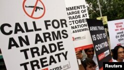 Activists campaigning for a global arms trade treaty hold placards during a protest in New Delhi, India, Sept. 13, 2006.