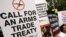 Activists campaigning for a global arms trade treaty hold placards during a protest in New Delhi, India, Sept. 13, 2006.