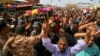 Mourners carry the coffins of two people, killed in protests at Baghdad's International Zone on Friday, during their funeral procession at the holy shrine of Imam Ali, in Najaf, 160 kilometers south of Baghdad, Iraq, May 21, 2016. 