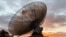 FILE - A radio telescope at the Parkes Observatory is pictured at sunset near the town of Parkes, Australia, July 15, 2019. The new Square Kilometre Array project will combine 130,000 antennas and 200 satellite dishes.