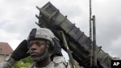 A U.S. soldier stands next to a Patriot surface-to-air missile battery at an army base in Morag, Poland, Wednesday, May 26, 2010. Polish and U.S. officials hailed the arrival in Poland of an American Patriot missile battery, saying Wednesday that the hard