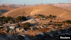 FILE - A general view shows the main part of the Palestinian Bedouin encampment of Khan al-Ahmar village that Israel plans to demolish, in the occupied West Bank, Sept. 11, 2018. 