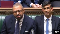 In an image taken from video, British Prime Minister Rishi Sunak, right, and British Home Secretary James Cleverly listen to a response after Cleverly spoke about the government's migrant deportation plan in the House of Commons, in London, on Dec. 6, 2023. (AFP photo/PRU)