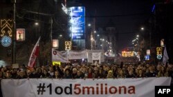 Protesters hold a banner reading '1 out of 5 million' during a demonstration against President Aleksandar Vucic, in Belgrade, Serbia, Feb. 9, 2019.