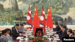 Chinese President Xi Jinping (2nd-R) meets Nepal Prime Minister Khadga Prasad Sharma Oli (2nd L) at the Great Hall of the People in Beijing, China March 21, 2016.