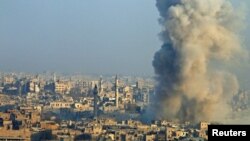 Smoke rises as seen from a rebel-held area of Aleppo, Syria, Dec. 12, 2016. 