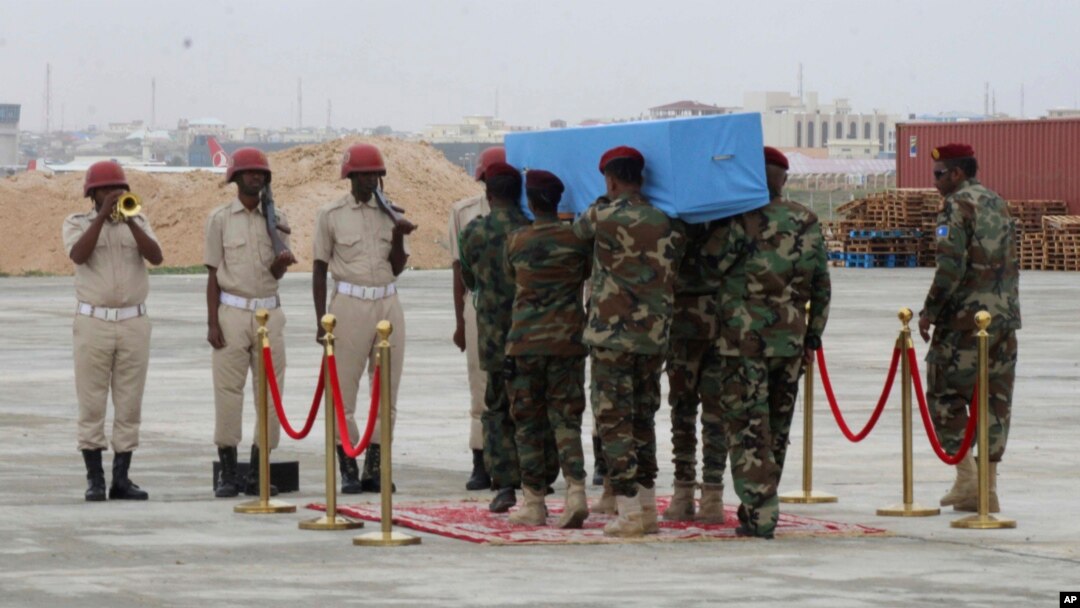Members of a Somali military unit carry the body of Mogadishu Mayor Abdirahman Omar Osman for burial, in Mogadishu, Somalia, Aug. 4, 2019. Osman was killed in a suicide bombing July 24.