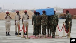 Members of a Somali military unit carry the body of Mogadishu Mayor Abdirahman Omar Osman for burial, in Mogadishu, Somalia, Aug. 4, 2019. Osman was killed in a suicide bombing July 24.