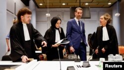 FILE - Oxfam Novib Director Michiel Servaes, and lawyers Thomas van der Sommen, Samira Sabir and Liesbeth Zegveld attend a hearing of a court case by human rights organisations against the export of F35 fighter jet parts to Israel in The Hague, Netherlands, December 4, 2023.