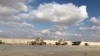 Sejumlah kendaran militer AS terlihat berada di pangkalan udara Ain al-Asad di provinsi Anbar, Irak, pada 13 Januarti 2020. (Foto: Reuters/John Davison)