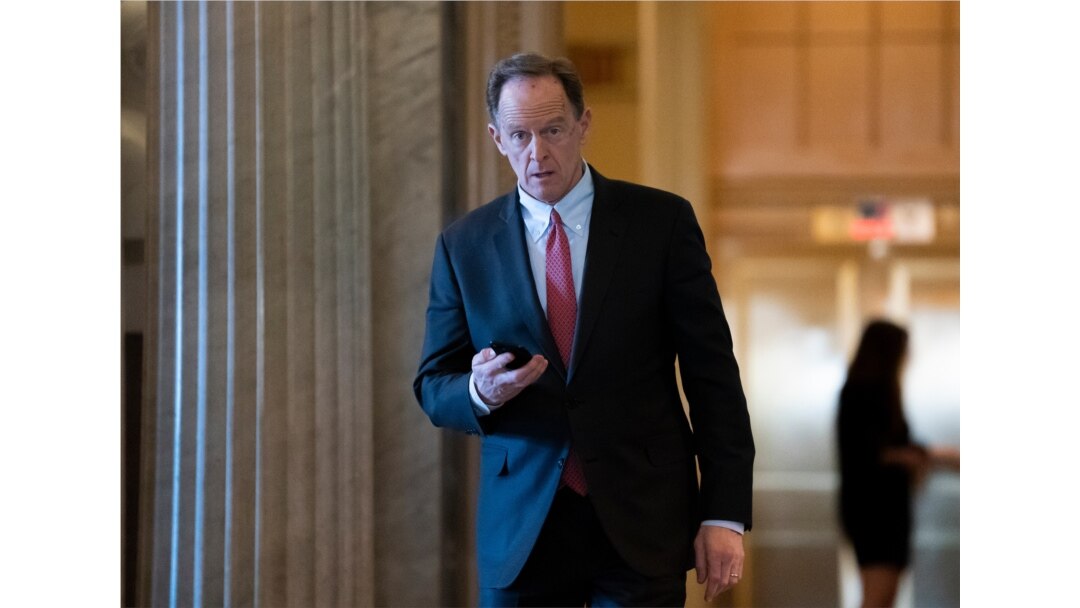 FILE - Sen. Pat Toomey, R-Pa., returns from a break in the impeachment trial of President Donald Trump on charges of abuse of power and obstruction of Congress, at the Capitol in Washington, Feb. 3, 2020.