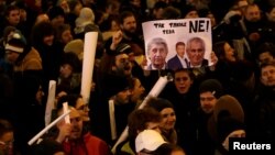 Demonstrators hold banners during a protest rally opposing the appointment of Communist member of parliament Zdenek Ondracek to chair a committee that oversees Czech police inspection in Prague, Czech Republic, March 5, 2018. The banner reads: "Not this way. No!"