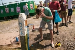 A festival goers pours water on his head at a water station on the third day of Glastonbury Festival at Worthy Farm, Somerset, England, June 28, 2019.