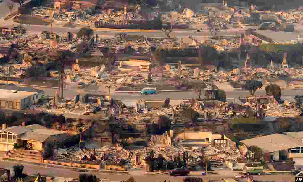 In this aerial view taken from a helicopter, burned homes are seen from above during the Palisades fire near the Pacific Palisades neighborhood of Los Angeles, California, on Jan. 9, 2025.