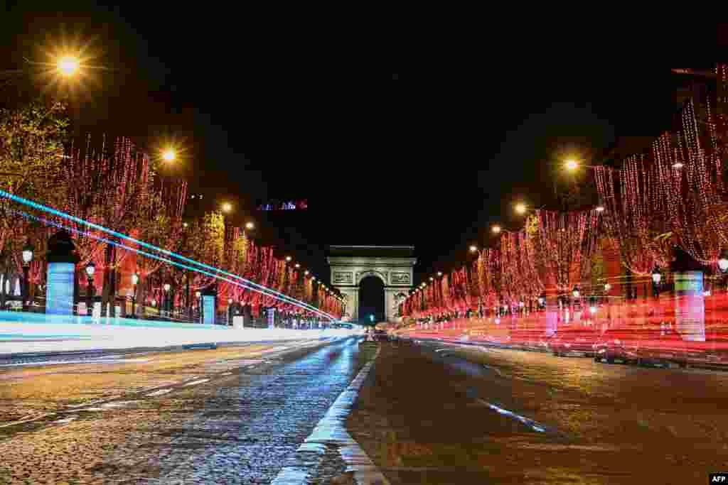 A general view of the Champs-Elysees Avenue and the Arc de Triomphe after the inauguration of the Christmas season light, in Paris, France.