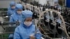 FILE - Workers of the Ryongaksan Soap Factory make disinfectant in Pyongyang, North Korea, March 19, 2020.