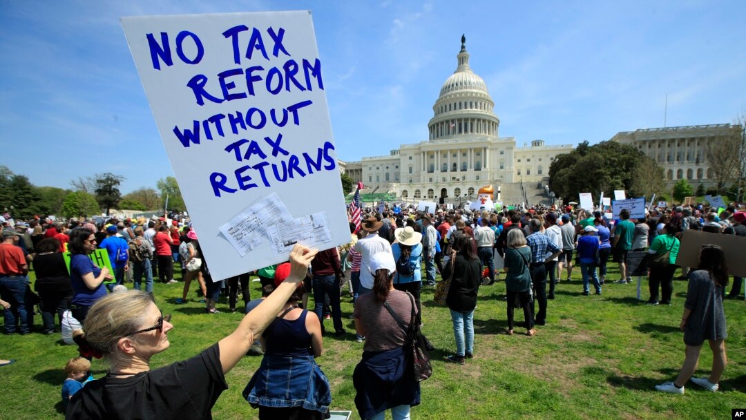 FILE - Protesters gather on Capitol Hill in Washington during a Tax Day demonstration calling on President Donald Trump to release his tax returns, April 15, 2017. 