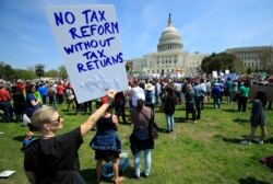 FILE - Protesters gather on Capitol Hill in Washington during a Tax Day demonstration calling on President Donald Trump to release his tax returns, April 15, 2017.