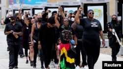 FILE: A group of mourners walk to the funeral service for Jayland Walker, a Black man who was shot to death by up to eight police officers on 6.27.2022 in Akron, Ohio, U.S. Taken 7.13.2022