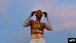 FILE - A supporter of Niger's National Council for the Safeguard of the Homeland (CNSP) demonstrates in Niamey on August 10, 2023.