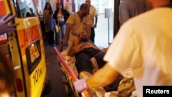 Israeli medics evacuate a man wounded in what police suspect was a Palestinian stabbing attack to Barzilai hospital in Ashkelon, Nov. 21, 2015.