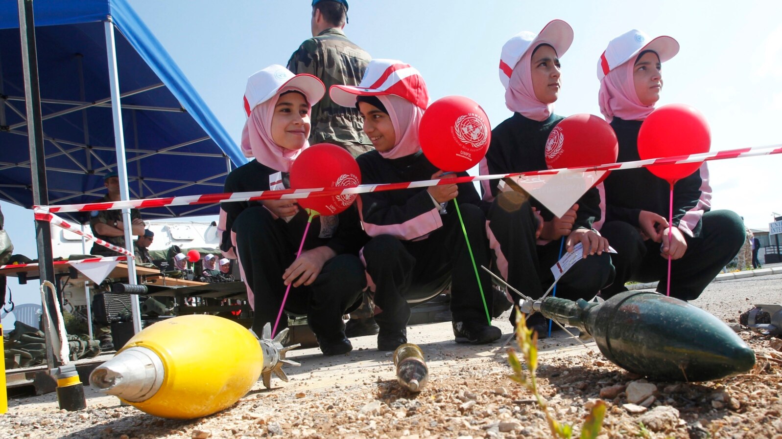 FILE - Schoolchildren attend an awareness campaign teaching them to identify mines and unexploded cluster bombs at the United Nations Interim Force in Lebanon (UNIFIL) headquarters in the town of Naqoura in southern Lebanon, April 4, 2014. 