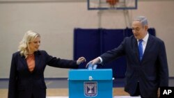 Le Premier ministre israélien Benjamin Netanyahu et son épouse Sara ont voté lors des élections législatives dans un bureau de vote à Jérusalem, le lundi 2 mars 2020. (Atef Safadi/Pool Photo via AP)