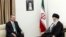 Supreme Leader Ayatollah Ali Khamenei (R) and Turkish Prime Minister Recep Tayyip Erdogan talk during their meeting in Tehran, Iran, Jan. 29, 2014. A portrait of the late Iranian revolutionary founder Ayatollah Khomeini hangs on the wall.