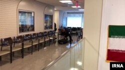 In this image published by Iranian state media, a U.S. officer detains Alireza Fakhar at the Iran Interests Section in Washington, April 25, 2018.