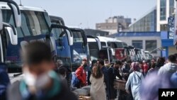 Travelers wait to board buses as they prepare to leave Istanbul from the city's Esenler national bus station, April 29, 2021, ahead of a new national COVID lockdown.