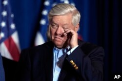 FILE — Senator Lindsey Graham, R-S.C., wipes his eye as Republican presidential candidate former President Donald Trump speaks at a primary election night party at the South Carolina State Fairgrounds in Columbia, S.C.,February 24, 2024.