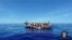 FILE Migrants sit in their boat during a rescue operation by Italian navy ship Grecale (unseen) off the coast of Sicily in this handout picture from the Italian Marina Militare, released May 6, 2016. 