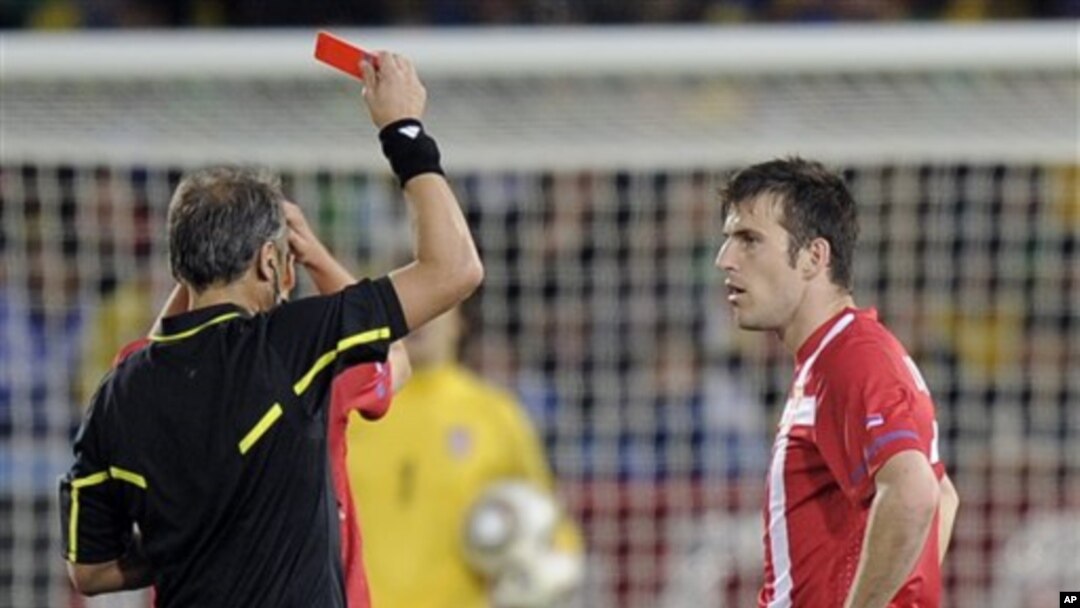 Argentine referee Hector Baldassi, left, gives a red card to Serbia's Aleksandar Lukovic during the World Cup group D soccer match between Serbia and Ghana at the Loftus Versfeld Stadium in Pretoria, South Africa, Sunday, June 13, 2010.