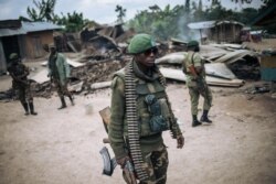 FILE - An Armed Forces of the Democratic Republic of Congo (FARDC) soldier takes part in a patrol in a village near Beni, Feb. 18, 2020, following an attack allegedly perpetrated by members of the rebel group Allied Democratic Forces.