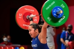 Philippines' Hidilyn Diaz competes in the women's 55kg weightlifting competition during the Tokyo 2020 Olympic Games at the Tokyo International Forum in Tokyo on July 26, 2021.