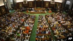 Newly elected lawmakers from India's ruling alliance led by the Hindu nationalist Bharatiya Janata Party raise their hands in support of Narendra Modi's election as their leader in New Delhi, May 25, 2019.