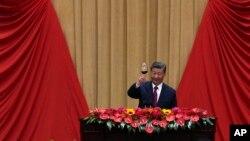 Chinese President Xi Jinping makes a toast on stage after delivering his speech at a dinner marking the 75th anniversary of the founding of the People's Republic of China, at the Great Hall of the People in Beijing, Sept. 30, 2024.