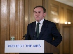 Britain's Secretary of State for the Environment George Eustice speaks during a Coronavirus press conference at Downing Street, in London, March 21, 2020.