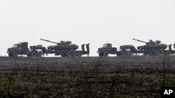 ইউক্রেনের লুহানস্ক অঞ্চলের দিকে ইউক্রেনীয় ট্যাঙ্ক নিয়ে যাওয়া হচ্ছে। ১২ ডিসেম্বর ২০২১। (ছবি-এপি/অন্দ্রি দুবচাক)