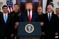 President Donald Trump addresses the nation on the ballistic missile strike that Iran launched against Iraqi air bases housing U.S. troops, Jan. 8, 2020, in Washington, as Vice President Mike Pence and others looks on.