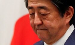 FILE - Japan's Prime Minister Shinzo Abe attends a news conference on Japan's response to the coronavirus outbreak at his official residence in Tokyo, March 14, 2020.
